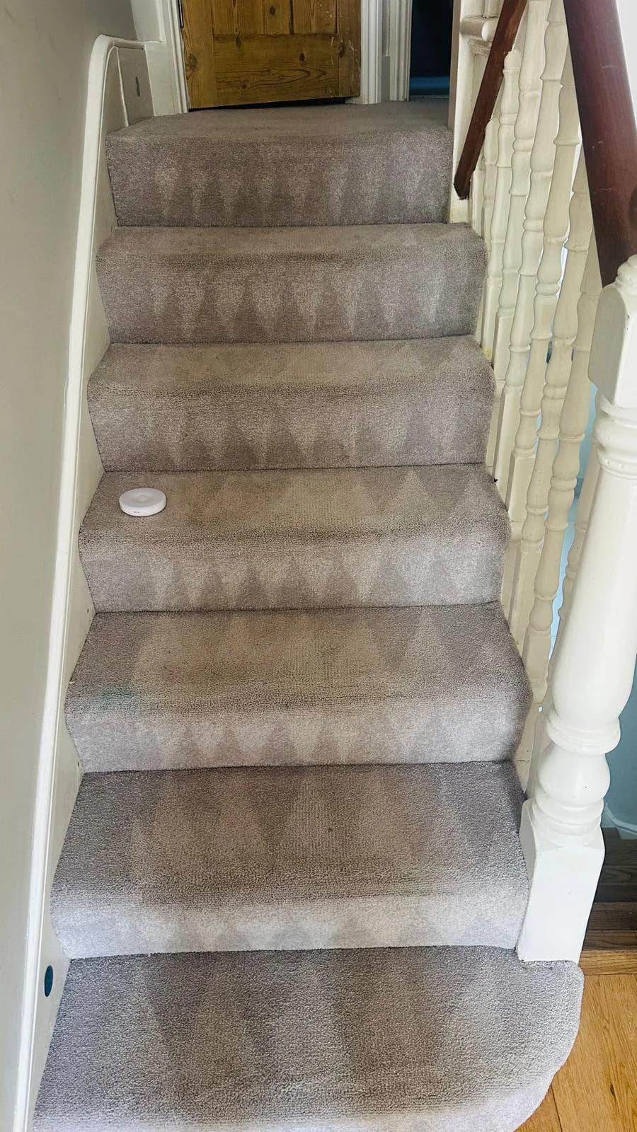The same stair carpet after cleaning, with a more even appearance and visible cleaning passes on the treads.